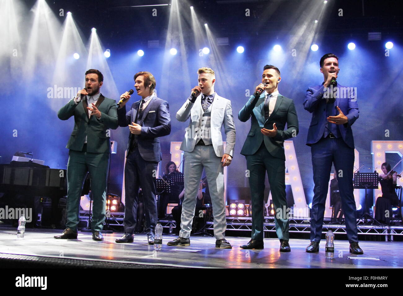 Betley, Cheshire, UK. 16th August, 2015. Collabro performs live at Betley Concerts held at Betley Court Farm, near Crewe, Cheshire. Collabro members Richard Hadfield, Thomas Redgrave, Matt Pagan, Michael Auger and Jamie Lambert entertain the crowd. Credit:  Simon Newbury/Alamy Live News Stock Photo