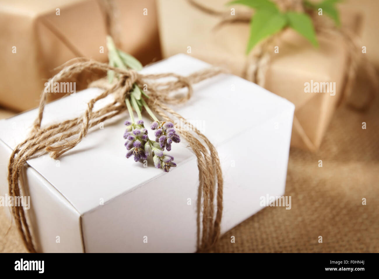 Handmade gift box with lavender sprig on burlap Stock Photo