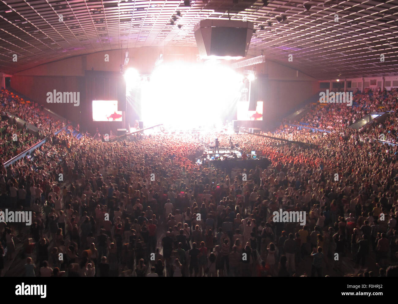 Numerous of cheering crowd in a concert hall during a rock concert Stock Photo