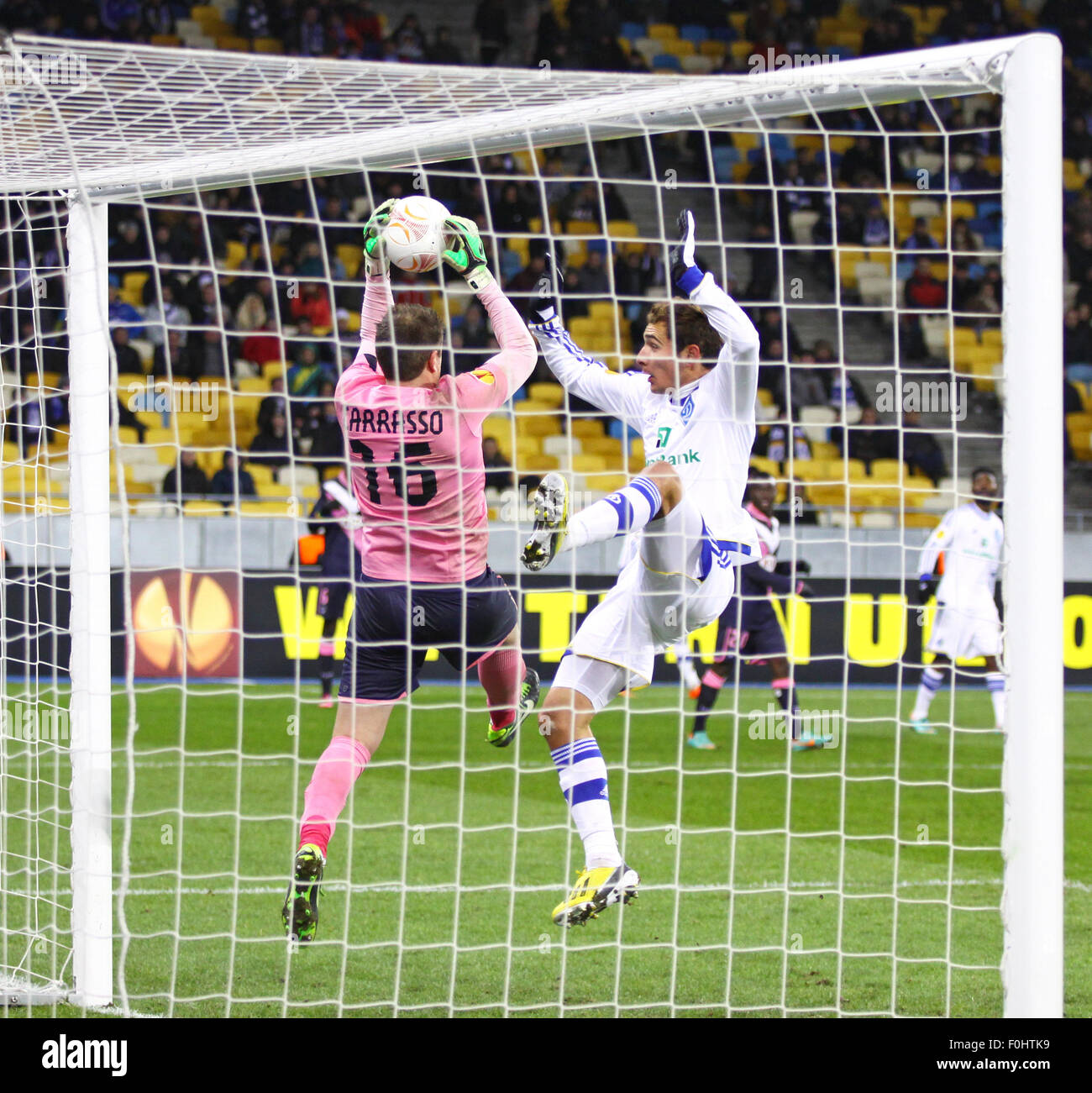 KYIV, UKRAINE - FEBRUARY 14, 2013: Marco Ruben of FC Dynamo Kyiv (in White) fights for the ball with goalkeeper Cedric Carrasso of FC Girondins de Bordeaux during their UEFA Europa League game on February 14, 2013 in Kyiv, Ukraine Stock Photo