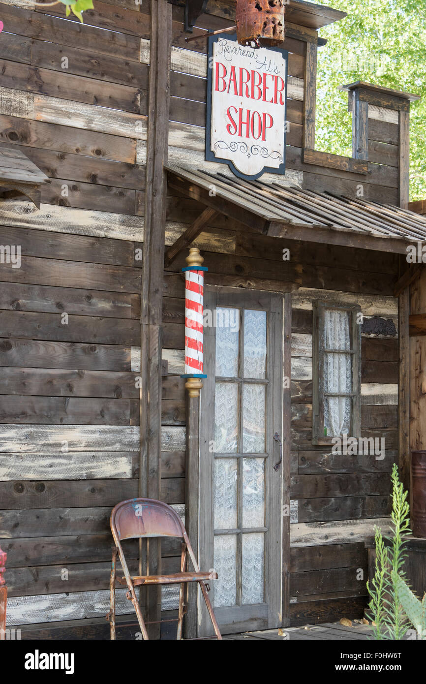 Wild west style Barbers shop exterior facade with red sign and red and