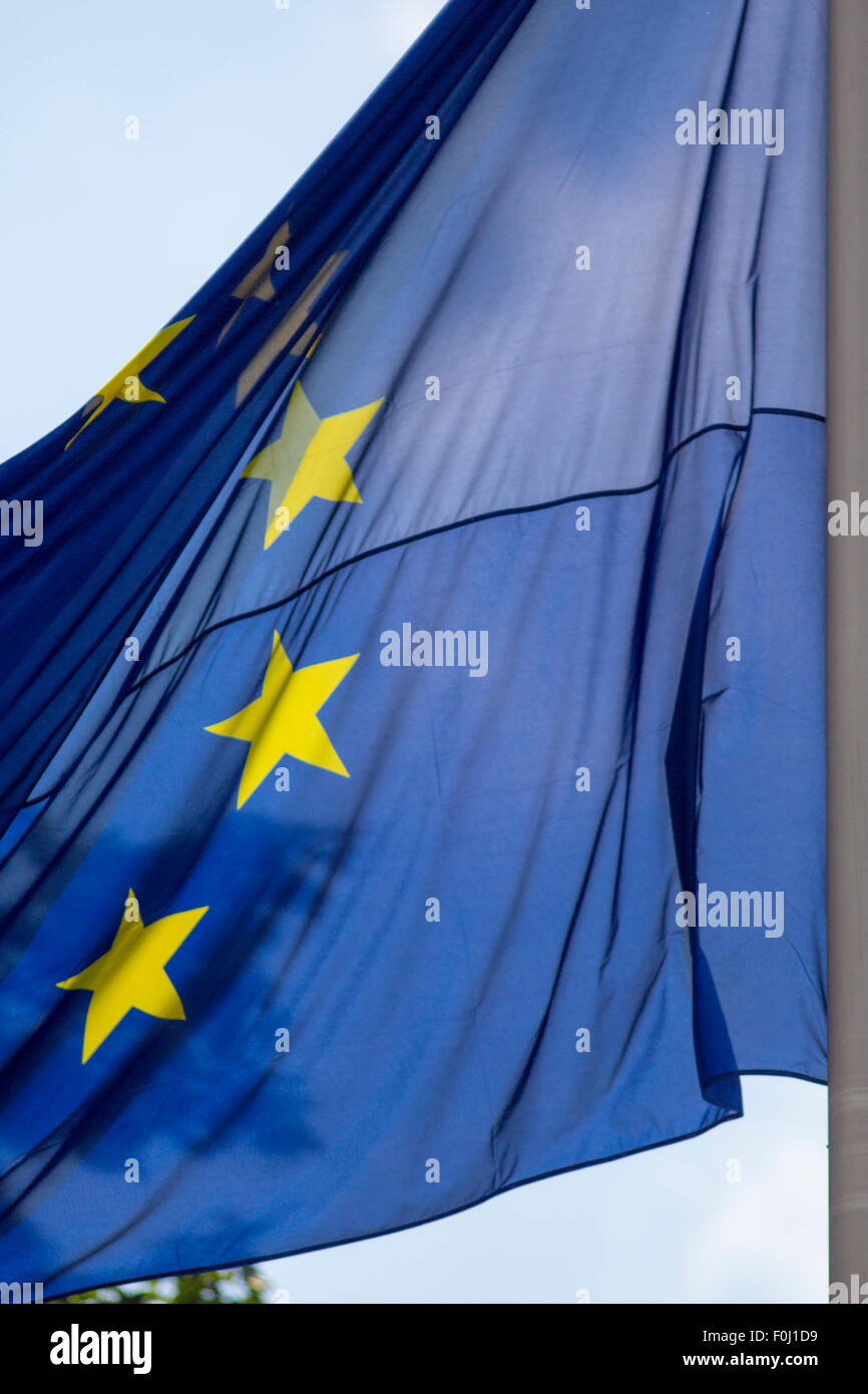 European EU flag waves in bright sun against a blue sky Stock Photo