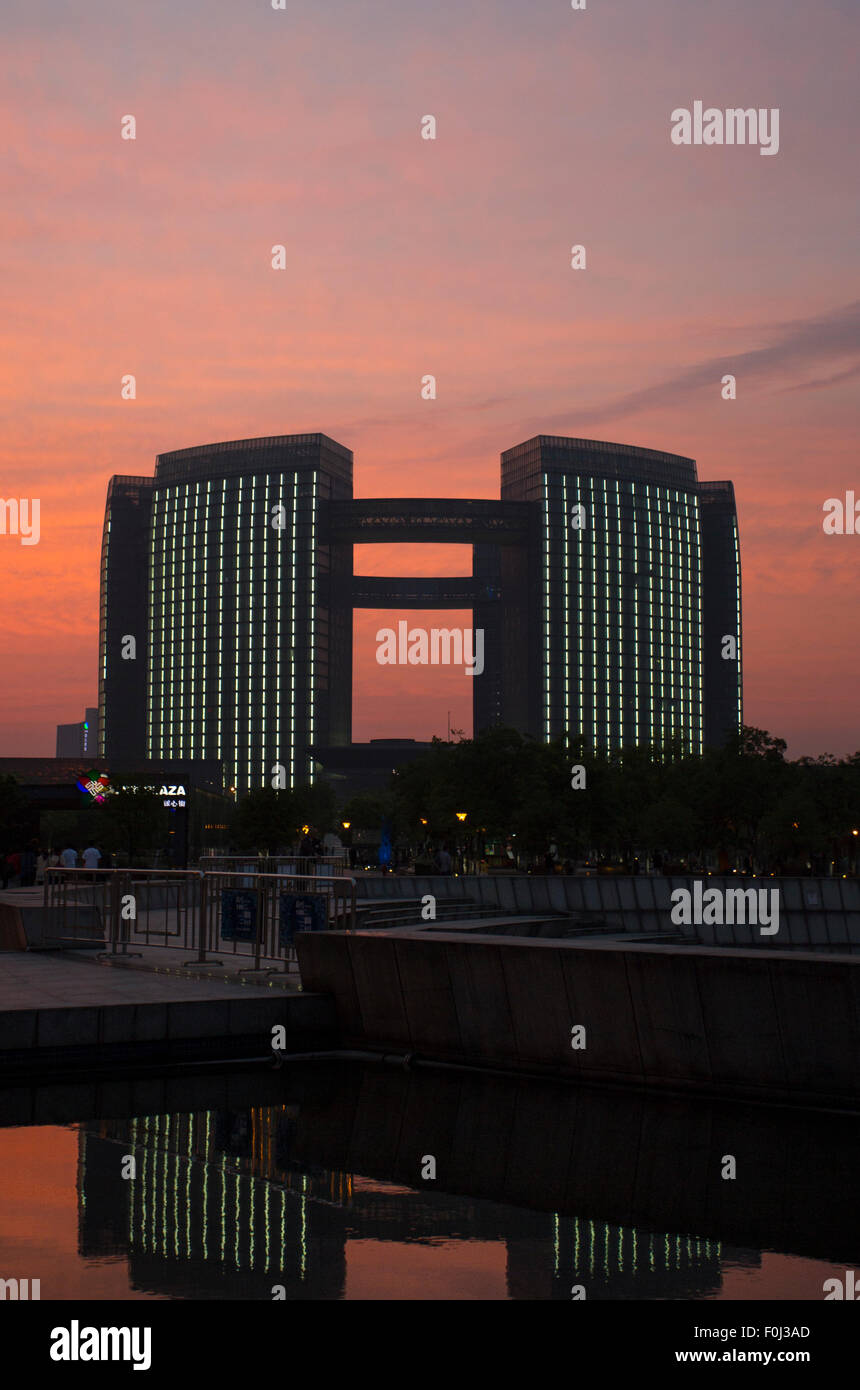 Modern office building in Hangzhou at night with a beautiful sunset, China Stock Photo