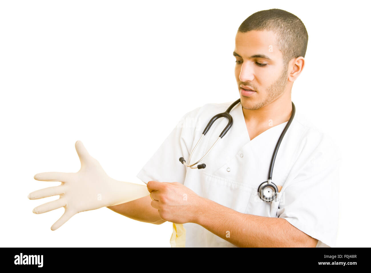 Young doctor putting on sterile plastic gloves Stock Photo