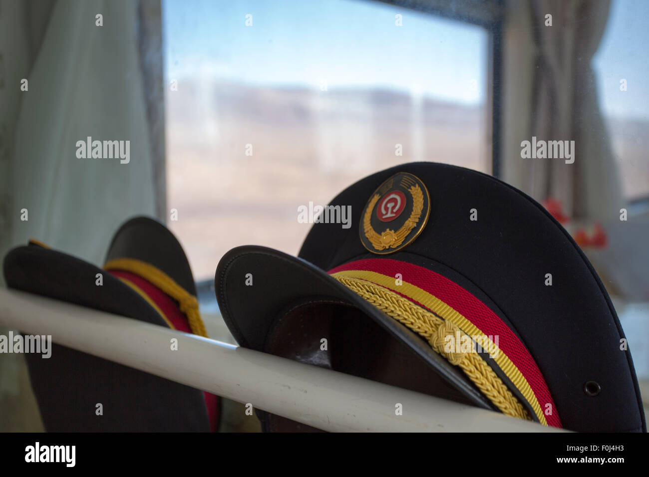 Two uniform-hats in the Train Lhasa - Shanghai.  China, 2013 Stock Photo