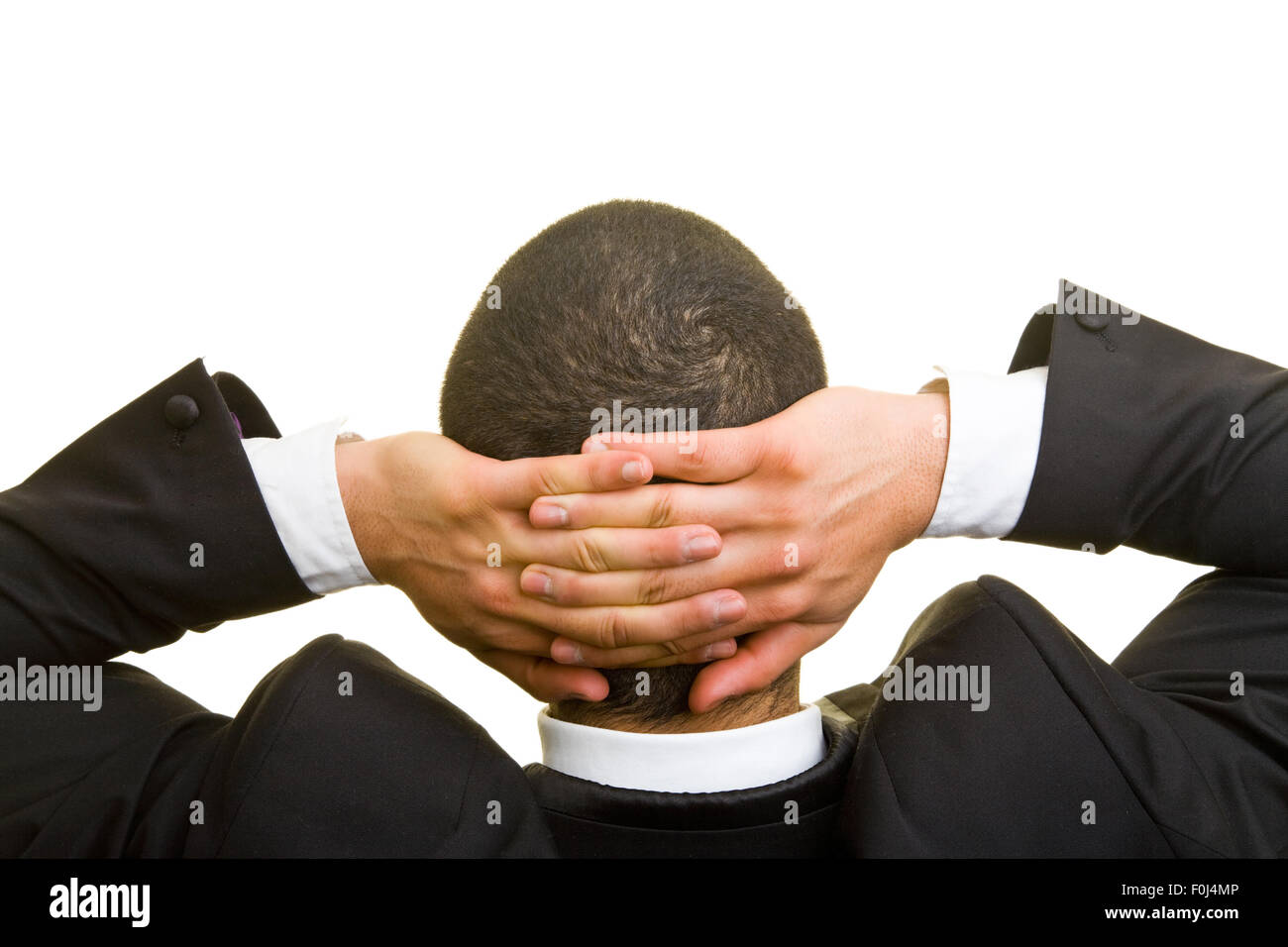 Business man leaning back with arms crossed behind his head Stock Photo