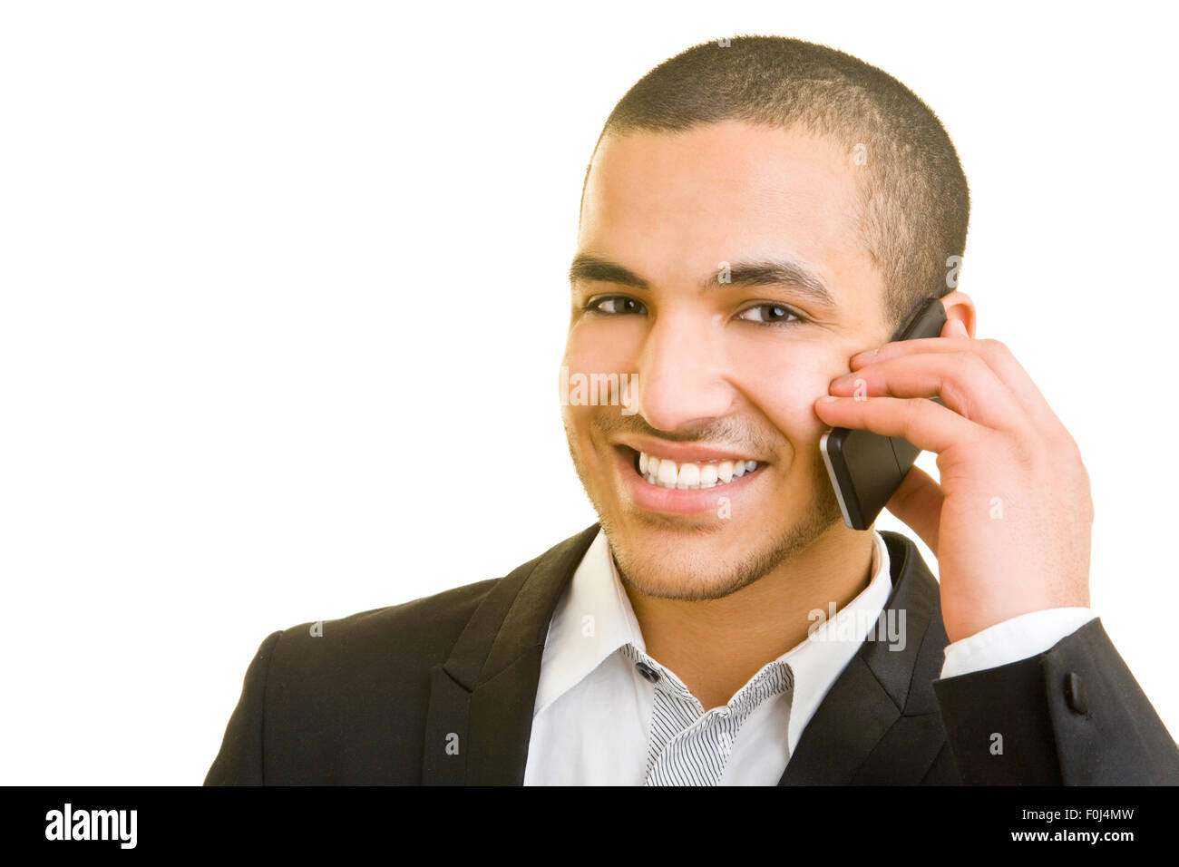 Young manager smiling while talking on his cell phone Stock Photo