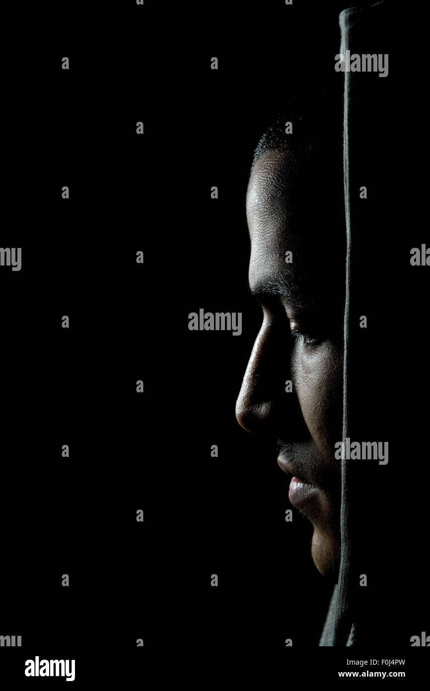 Dark portrait of a young moroccan man with hoodie Stock Photo