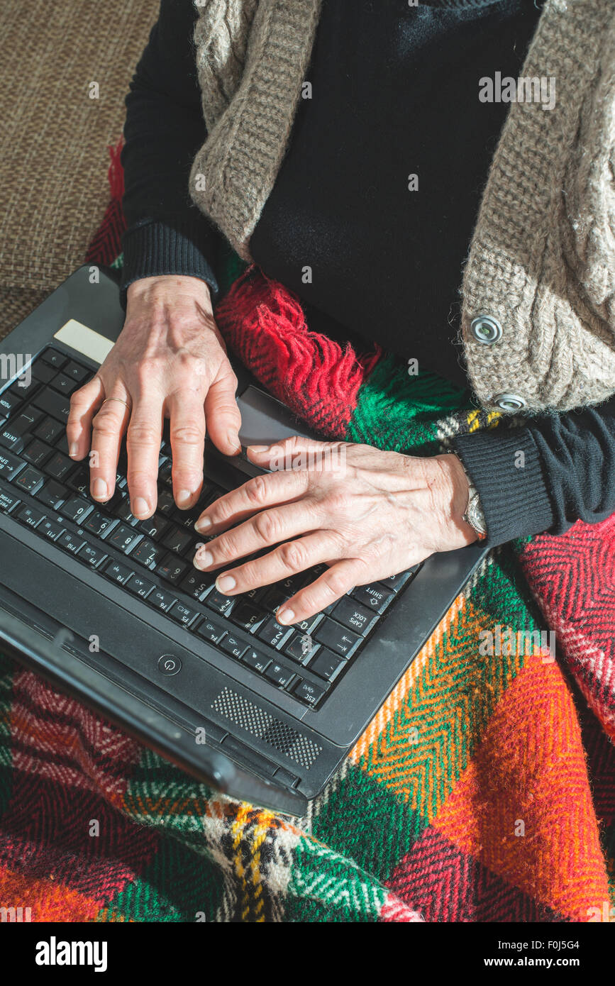 Old women using old laptop Stock Photo