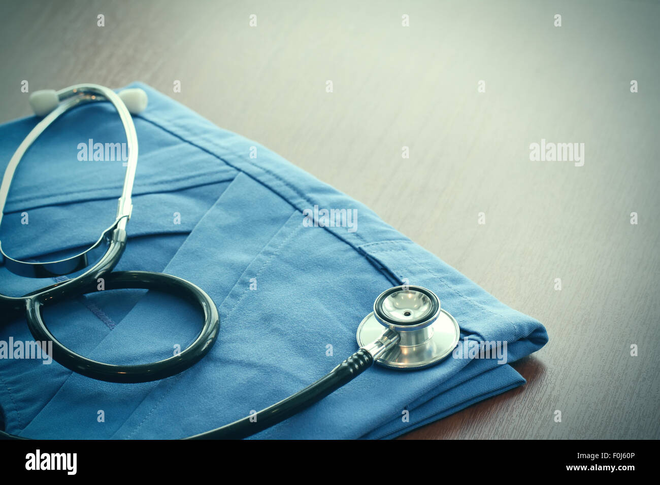 Studio macro of a stethoscope and digital tablet abstract on wood table ...