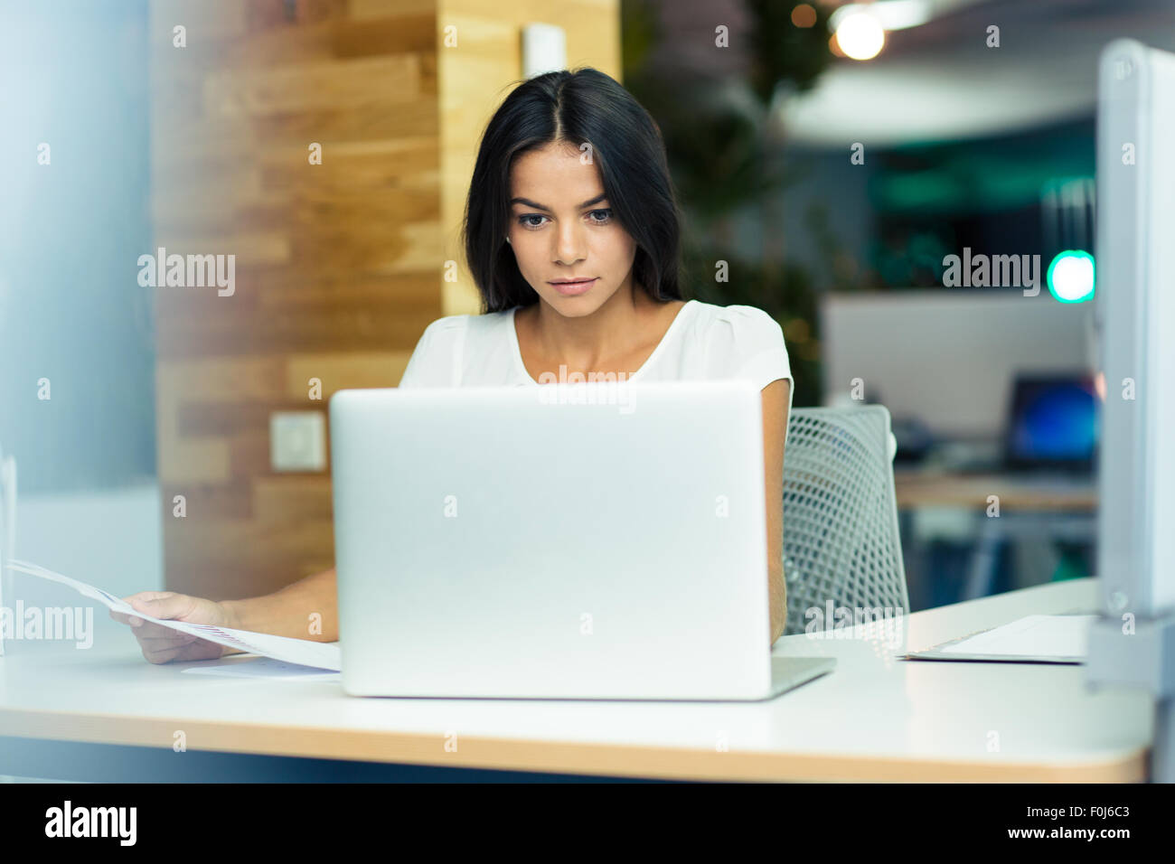 Portrait of a lovely businesswoman working in office Stock Photo - Alamy
