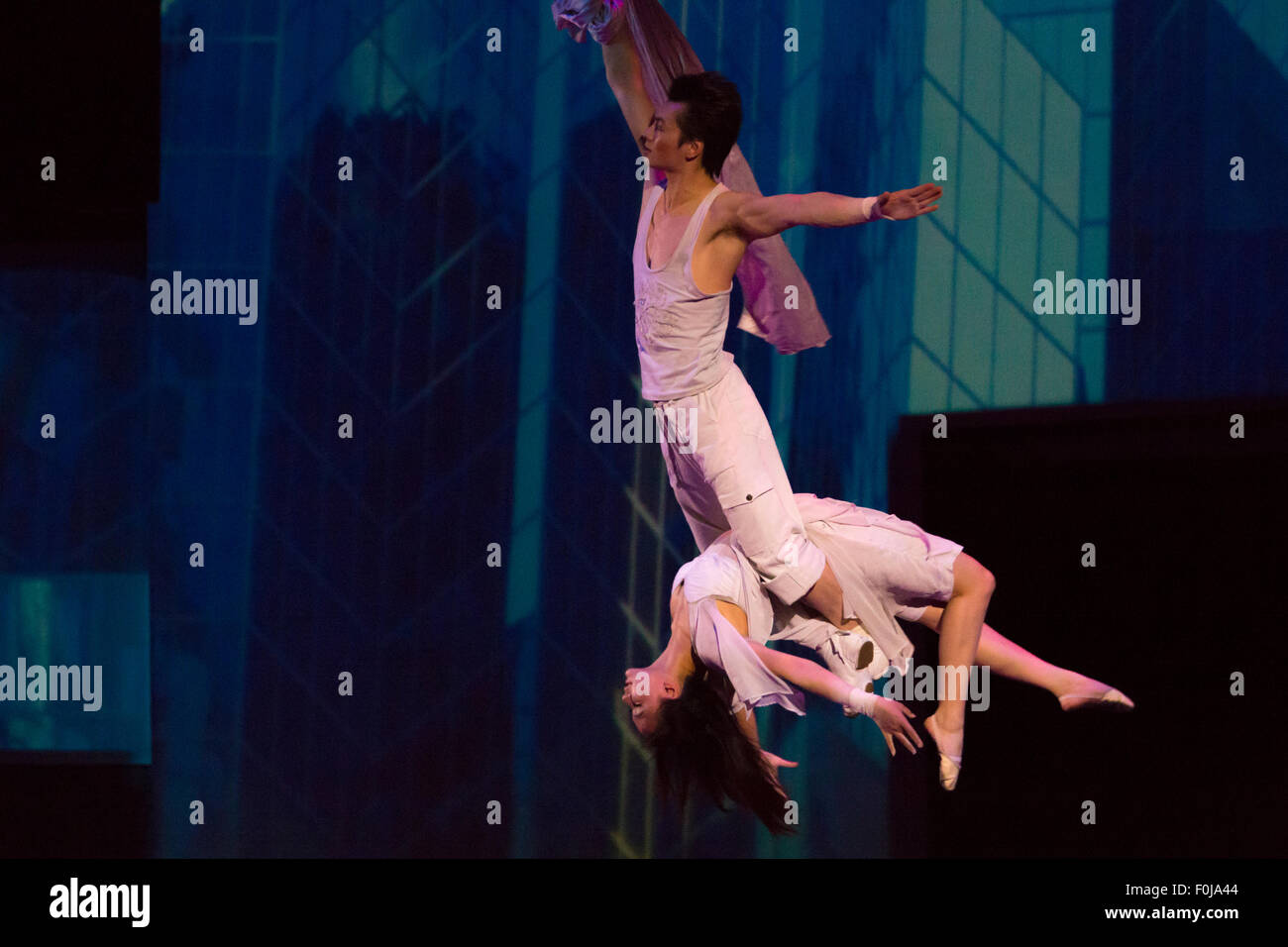 Unidentified Couple of acrobats hanging on a wire  a circus in Shanghai, 2013 Stock Photo