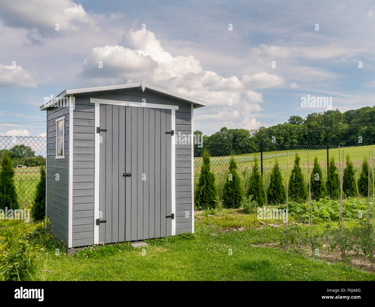 Wooden garden tools shed painted in gray color Stock Photo