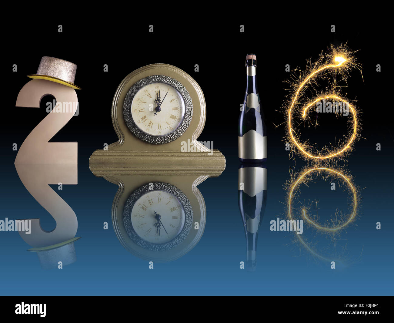 New Year 2016 set up of golden digit two, table clock, bottle of champagne and digit six created from burning sparkler Stock Photo