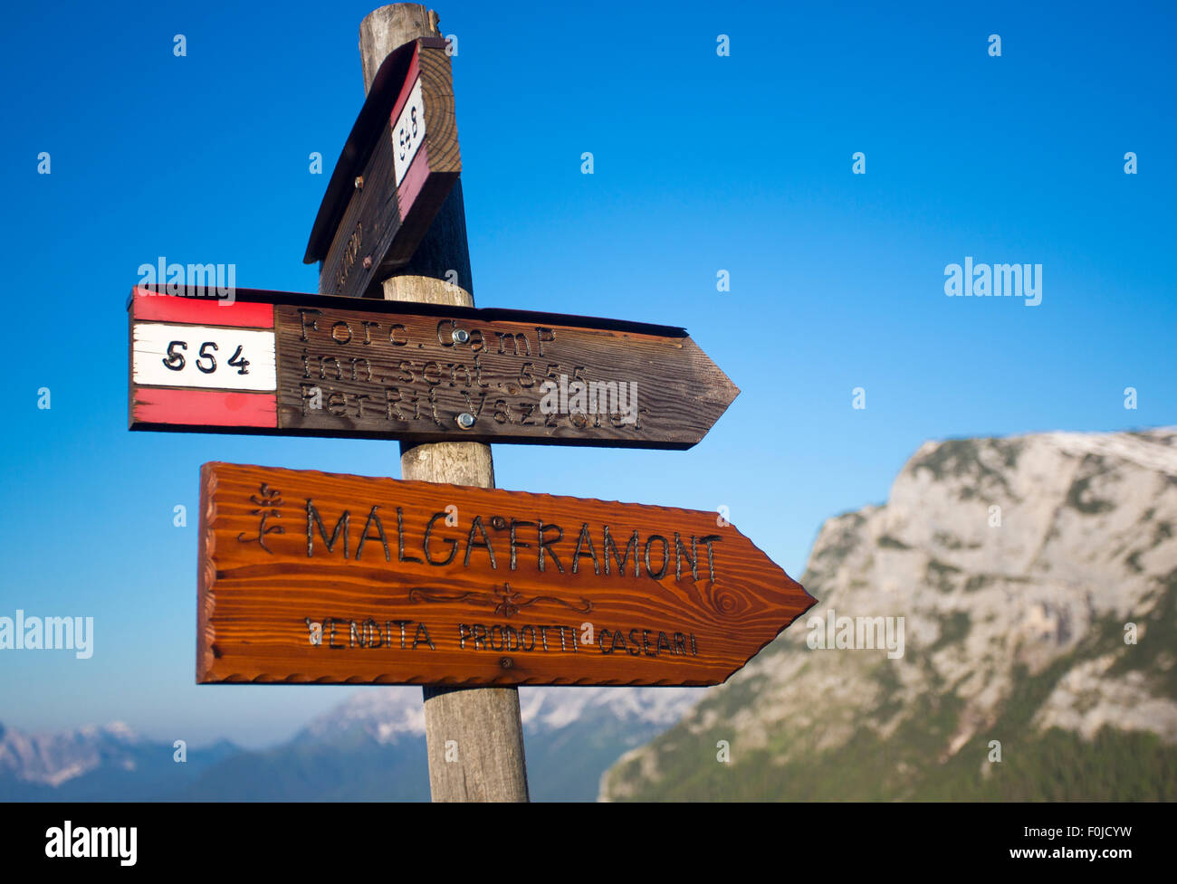 Foro Camp signs with blue sky and blurred mountains in the background, Dolomite, Italy Stock Photo