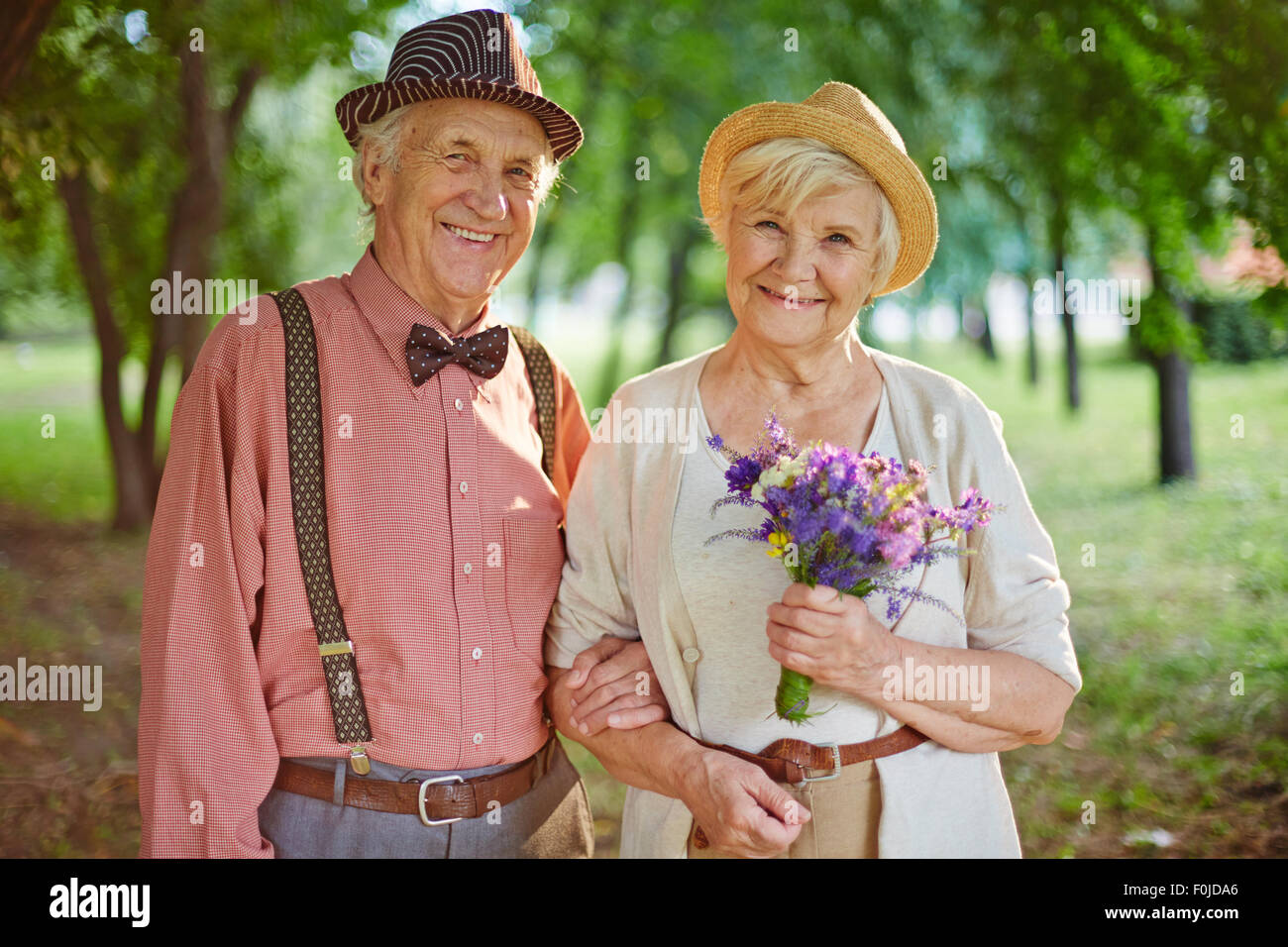 Happy aged couple enjoying weekend in park Stock Photo