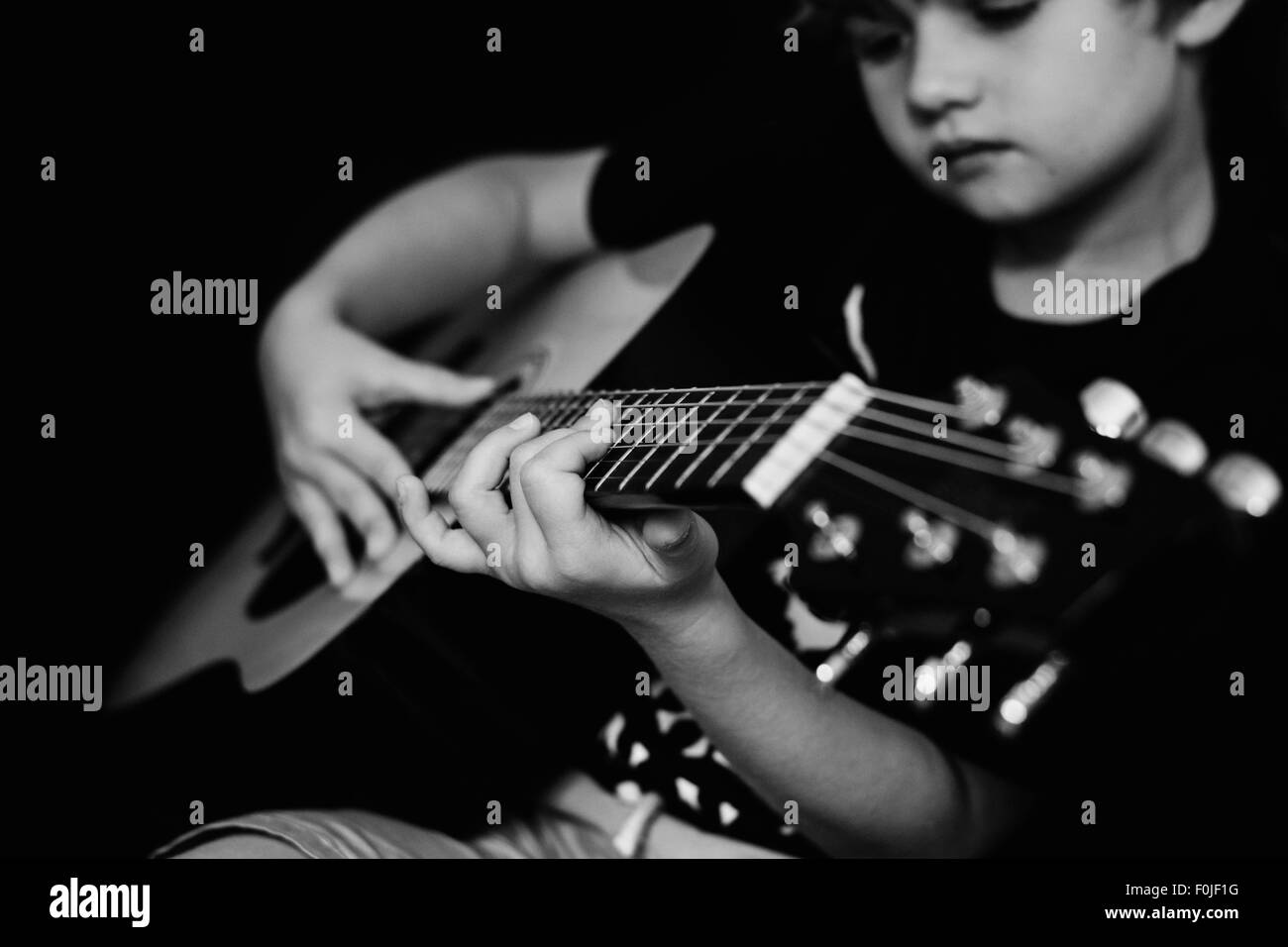 boy playing his guitar Stock Photo