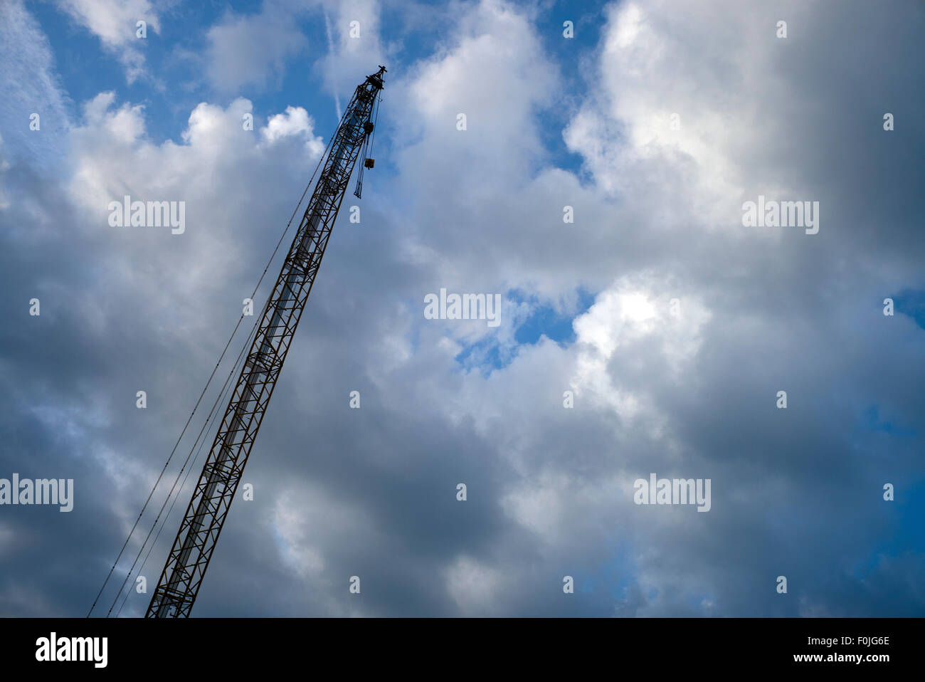 Tall crane against blue cloudy sky Stock Photo - Alamy