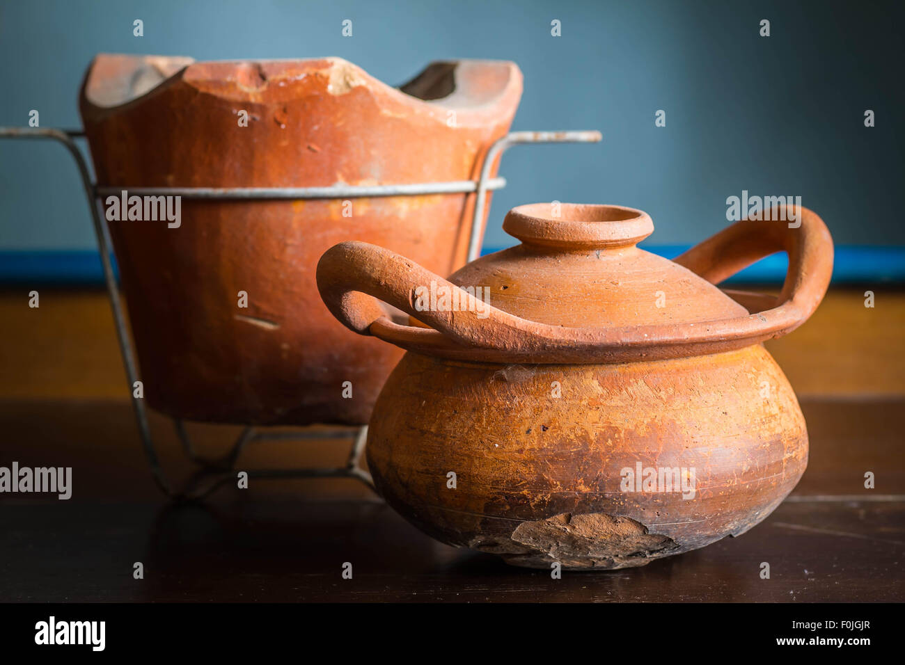 Old clay pot with cracks on wood Stock Photo Alamy