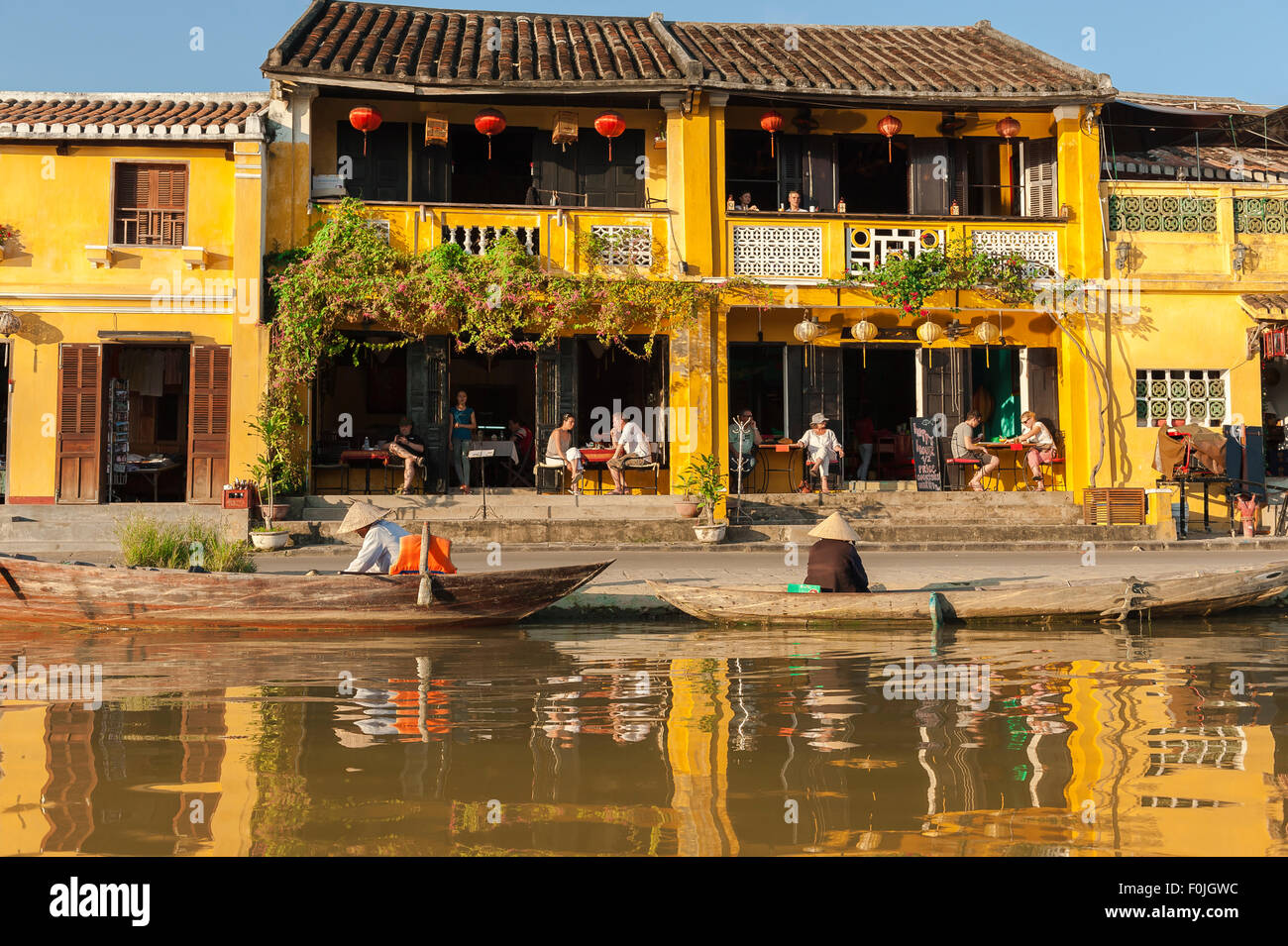 Vietnam color sunset, view of late afternoon sunshine illuminating the colorful waterfront tourist quarter in Hoi An, Vietnam Stock Photo