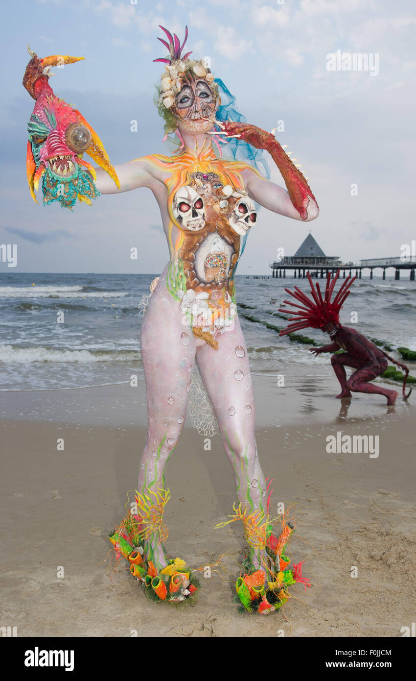 Models Edyta and Sven (L-R) present creations by body painting artists  taking part in a body painting festival at a beach of the sea beach resort  Heringsdorf on Usedom island, Germany, 15