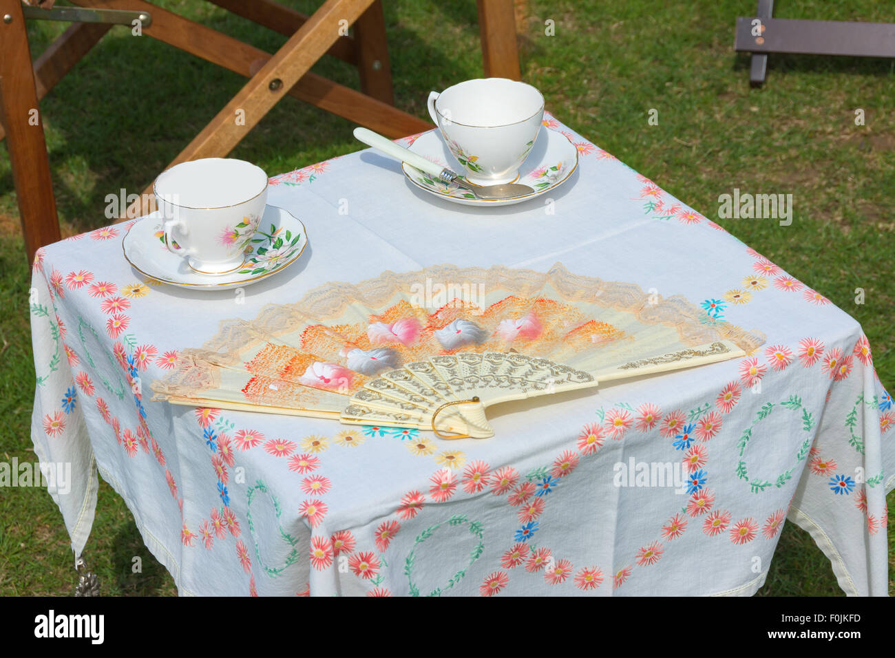 Picnic table set with two china cups and saucers Stock Photo Alamy