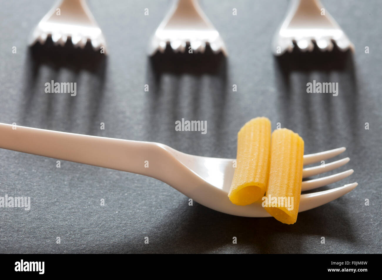 pasta on plastic forks Stock Photo