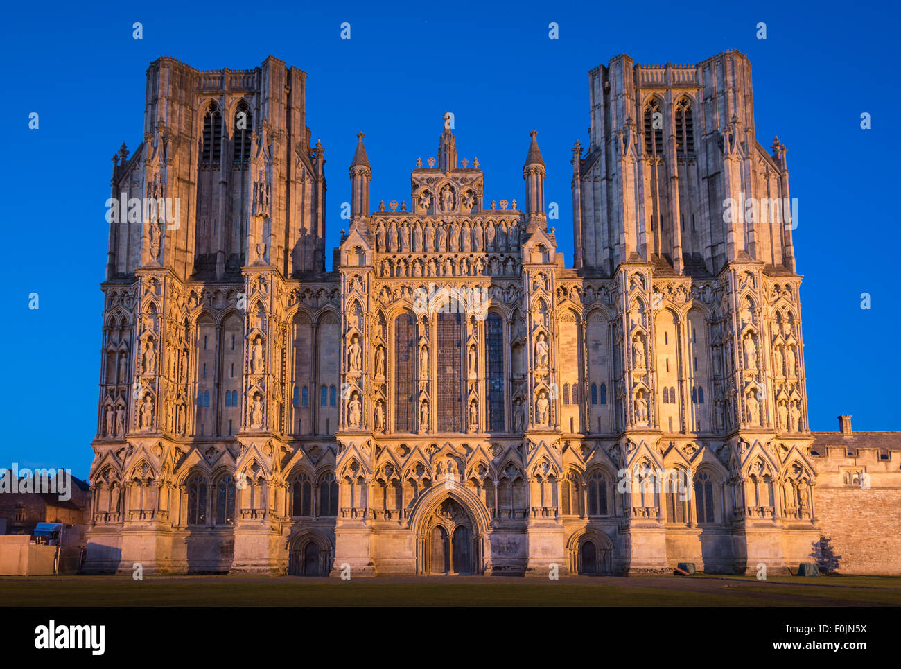 The Early English Gothic West front of Wells Cathedral in the small city of Wells, Somerset, England, UK, taken in the blue hour Stock Photo