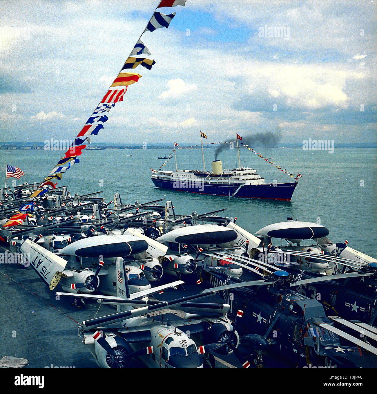 AJAXNETPHOTO - (PMO) 16 MAY 1969. - ROYAL INSPECTION - THE ROYAL YACHT BRITANNIA CARRYING QUEEN ELIZABETH II, THE DUKE OF EDINBURGH AND PRINCESS ANNE, PICTURED OFF SPITHEAD FROM THE DECK OF THE USS WASP, DURING THE ROYAL REVIEW OF 61 WARSHIPS OF TWELVE N.A.T.O. (NORTH ATLANTIC TREATY ORGANISATION) COUNTRIES.  PHOTO:JONATHAN EASTLAND/AJAX REF:C6919 10 Stock Photo