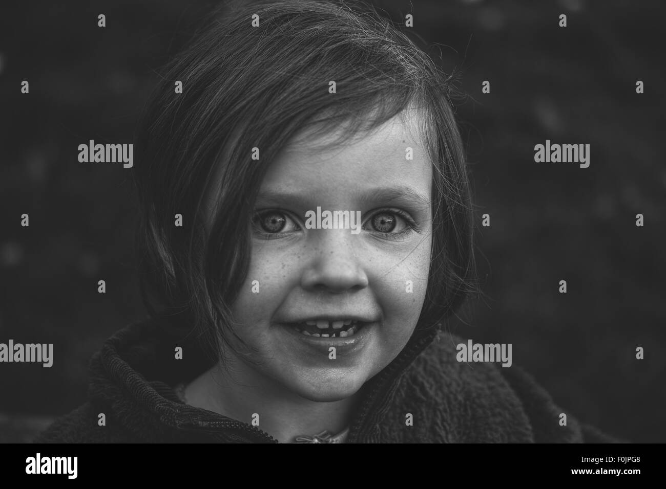 A young girl smiling at the camera Stock Photo - Alamy