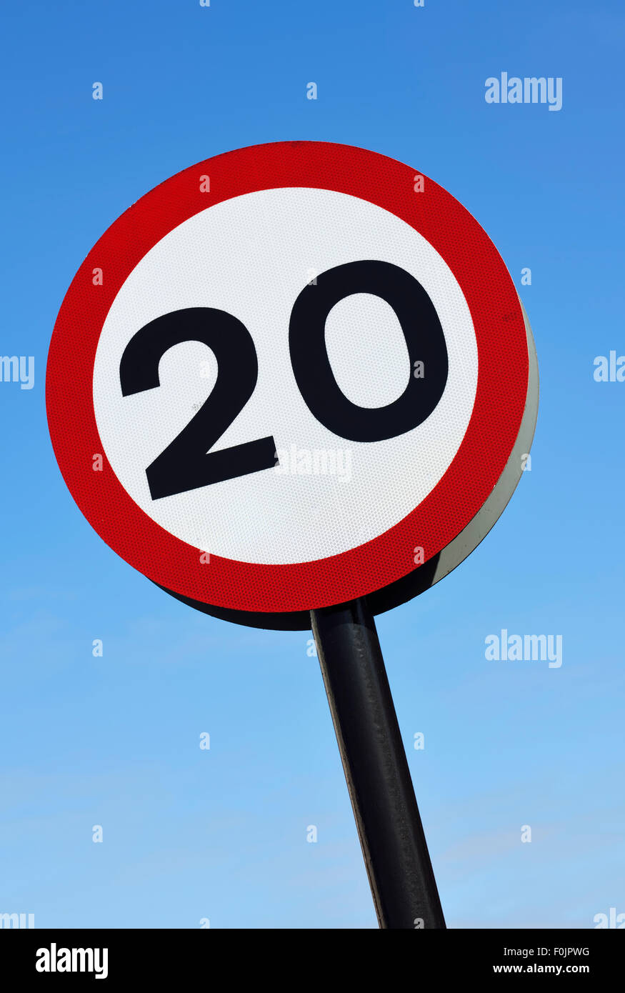 20mph speed limit road sign against blue sky Stock Photo