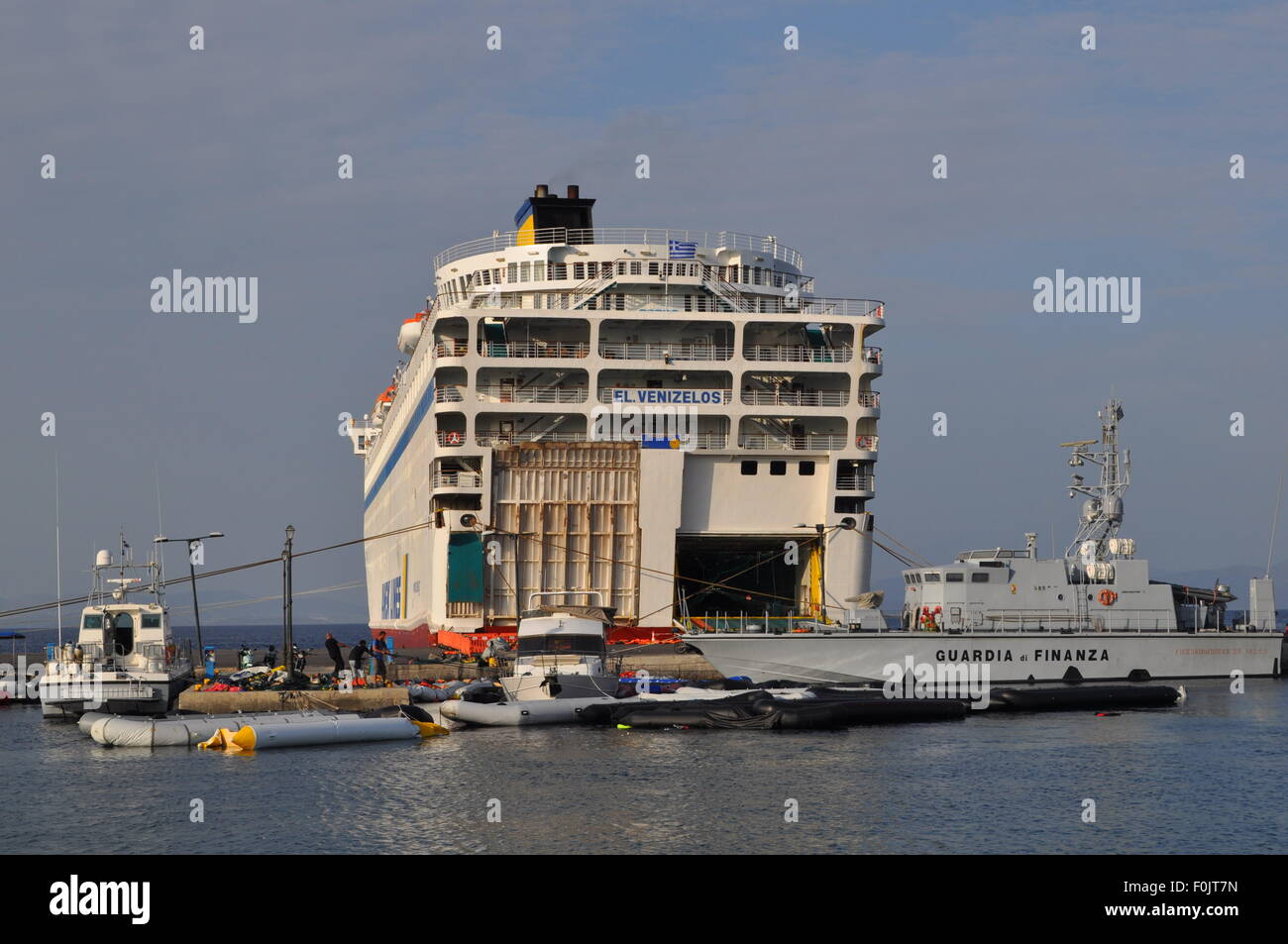 Kos, Greece. 15th Aug, 2015. Migrants and refugees wait at the port next to the ferry Eleftherios Venizelos after crossing from Turkey, at the southeastern island of Kos, Greece, Sturday, August 15, 2015. © Tereza Supova/CTK Photo/Alamy Live News Stock Photo
