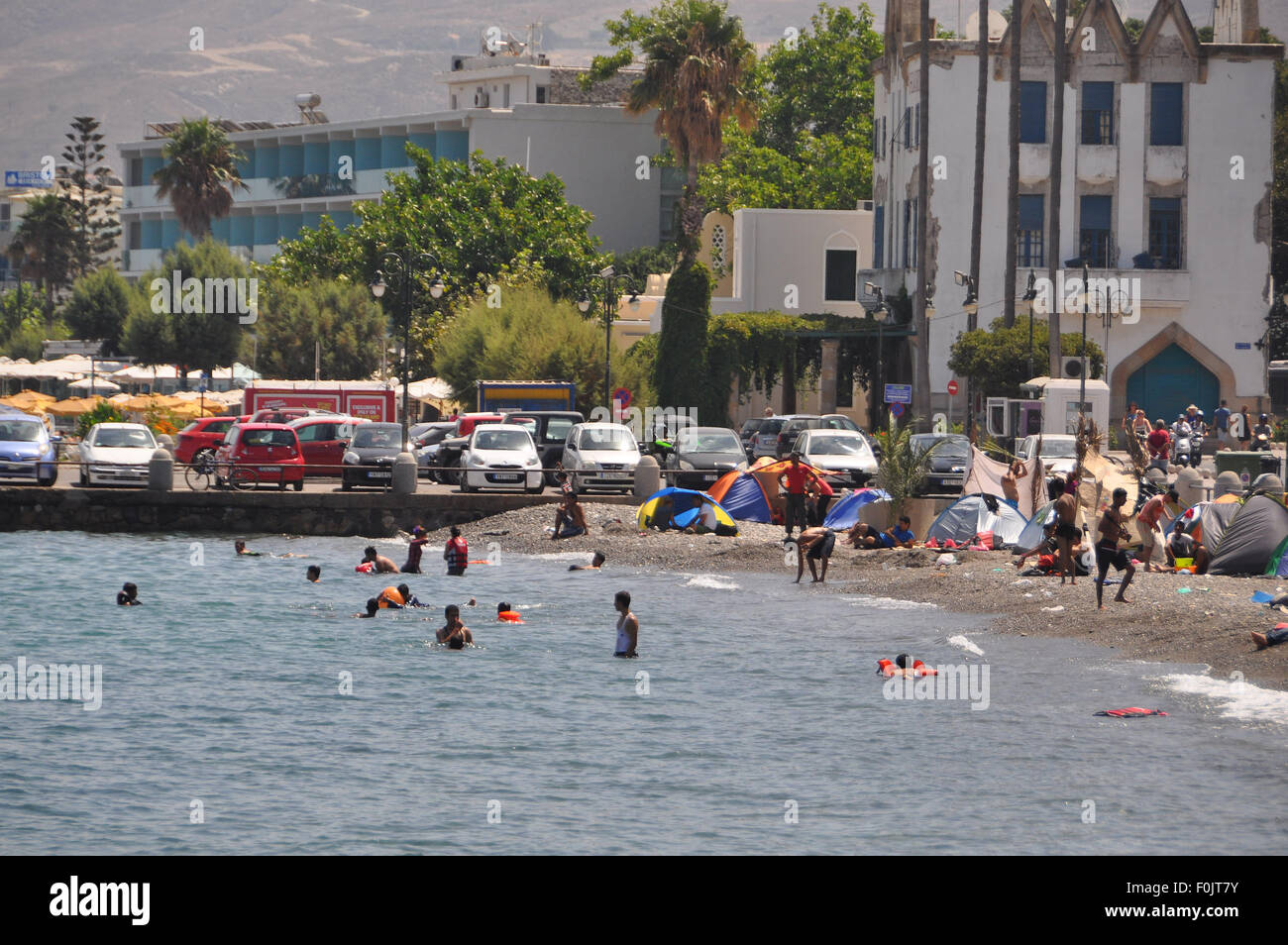 Kos, Greece. 16th Aug, 2015. Migrants and refugees wait at the port next to the ferry Eleftherios Venizelos after crossing from Turkey, at the southeastern island of Kos, Greece, Sturday, August 16, 2015. © Tereza Supova/CTK Photo/Alamy Live News Stock Photo