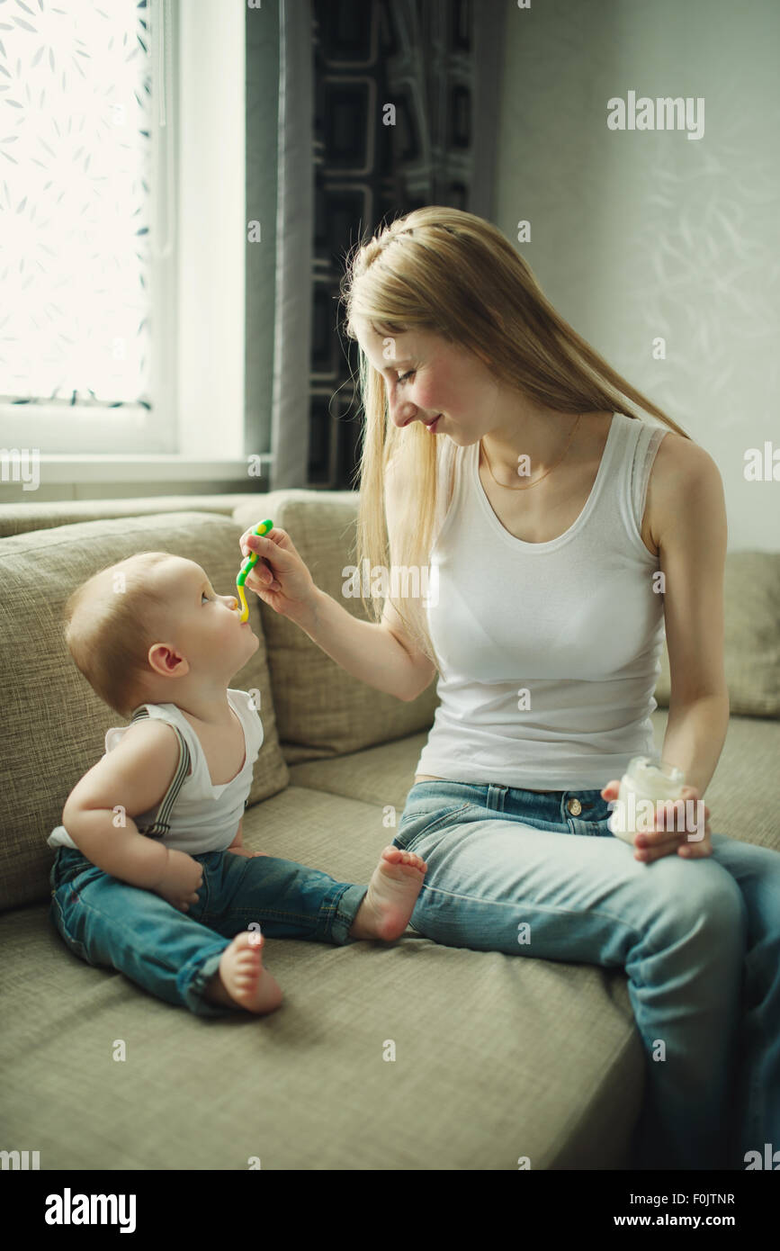 mother feeding baby with a spoon Stock Photo