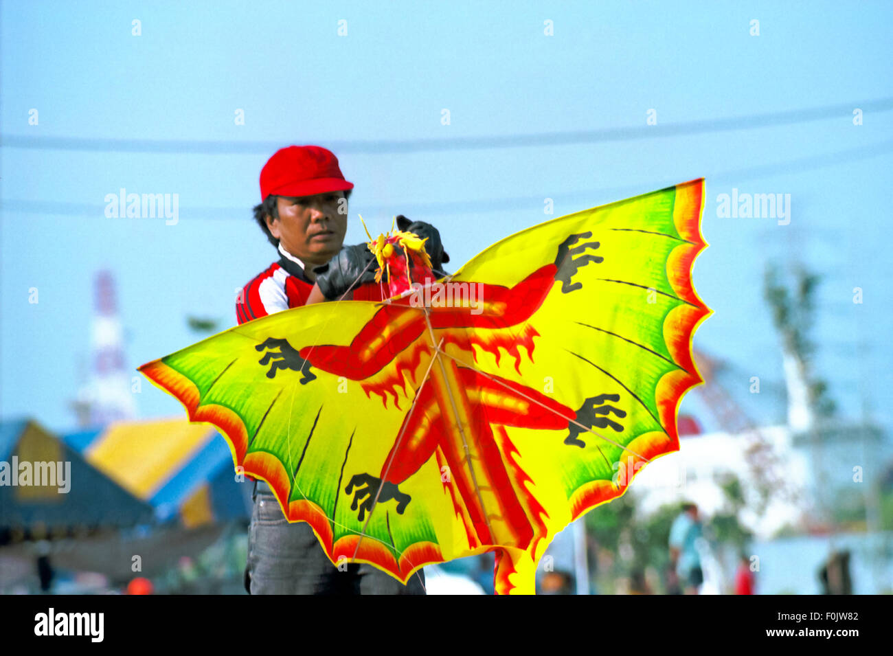 A man prepares his kite during the 2004 Jakarta International Kite Festival at Carnival Beach, Ancol, North Jakarta, July 09-11, 2004. Stock Photo