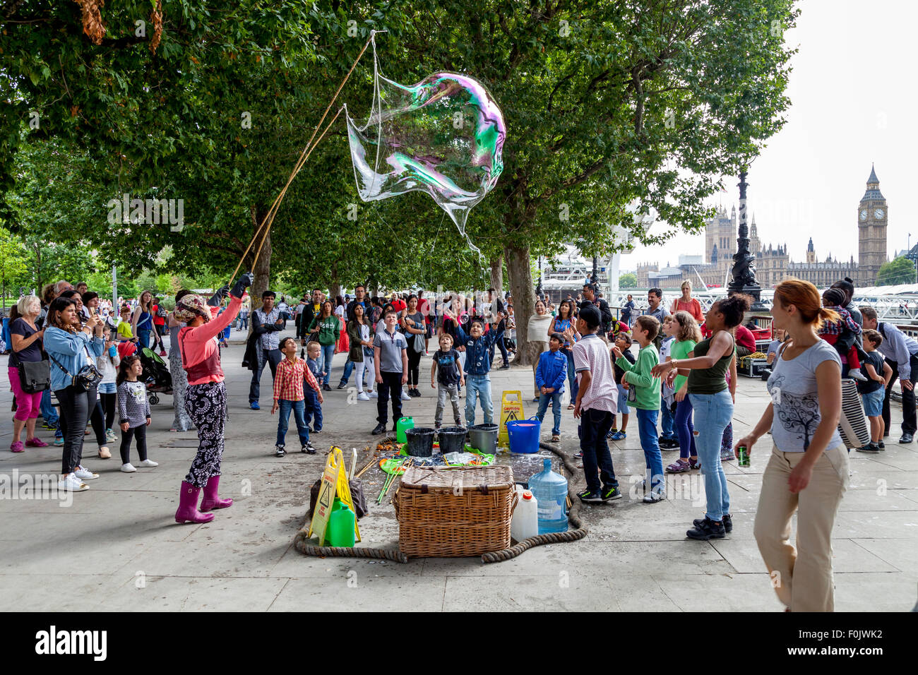 A Street Entertainer and Her Bubble Show, The Southbank, London, England Stock Photo