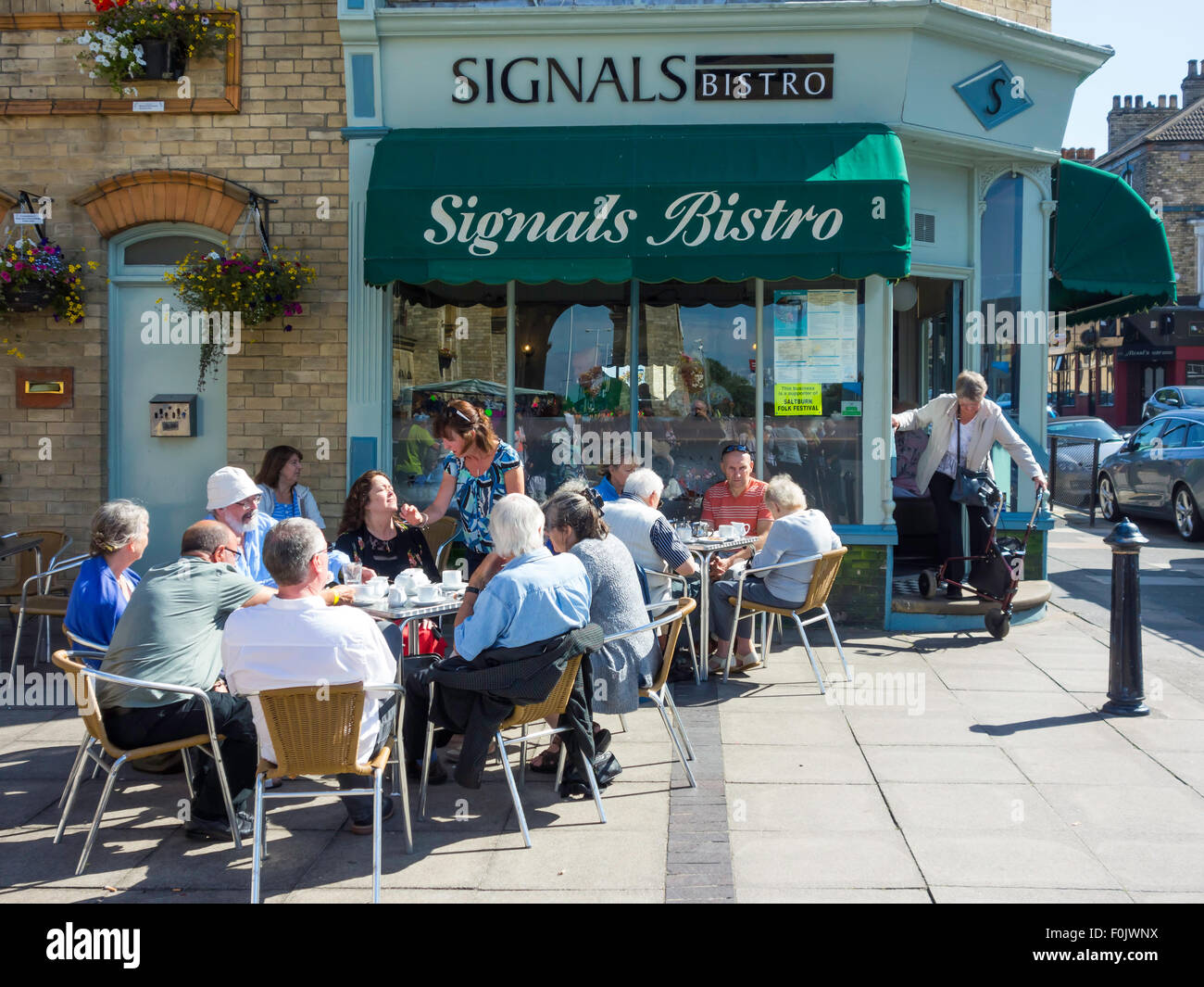 Customers with dogs enjoying breakfast in Summmer sunshine at Signals Bistro Saltburn by the Sea North Yorkshire England Stock Photo