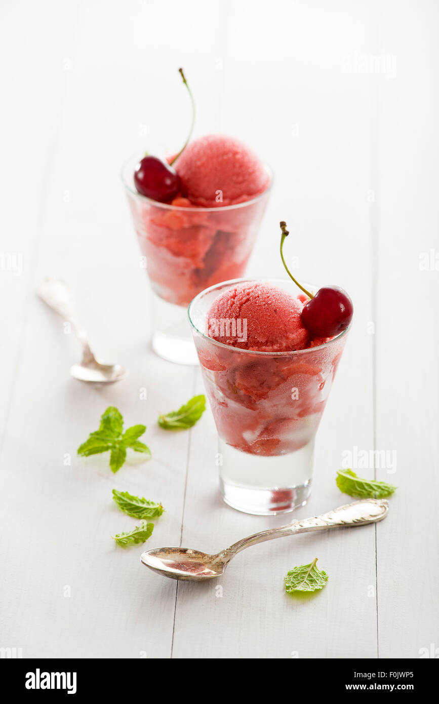 Fresh cherry ice cream or sorbet in glass. Stock Photo