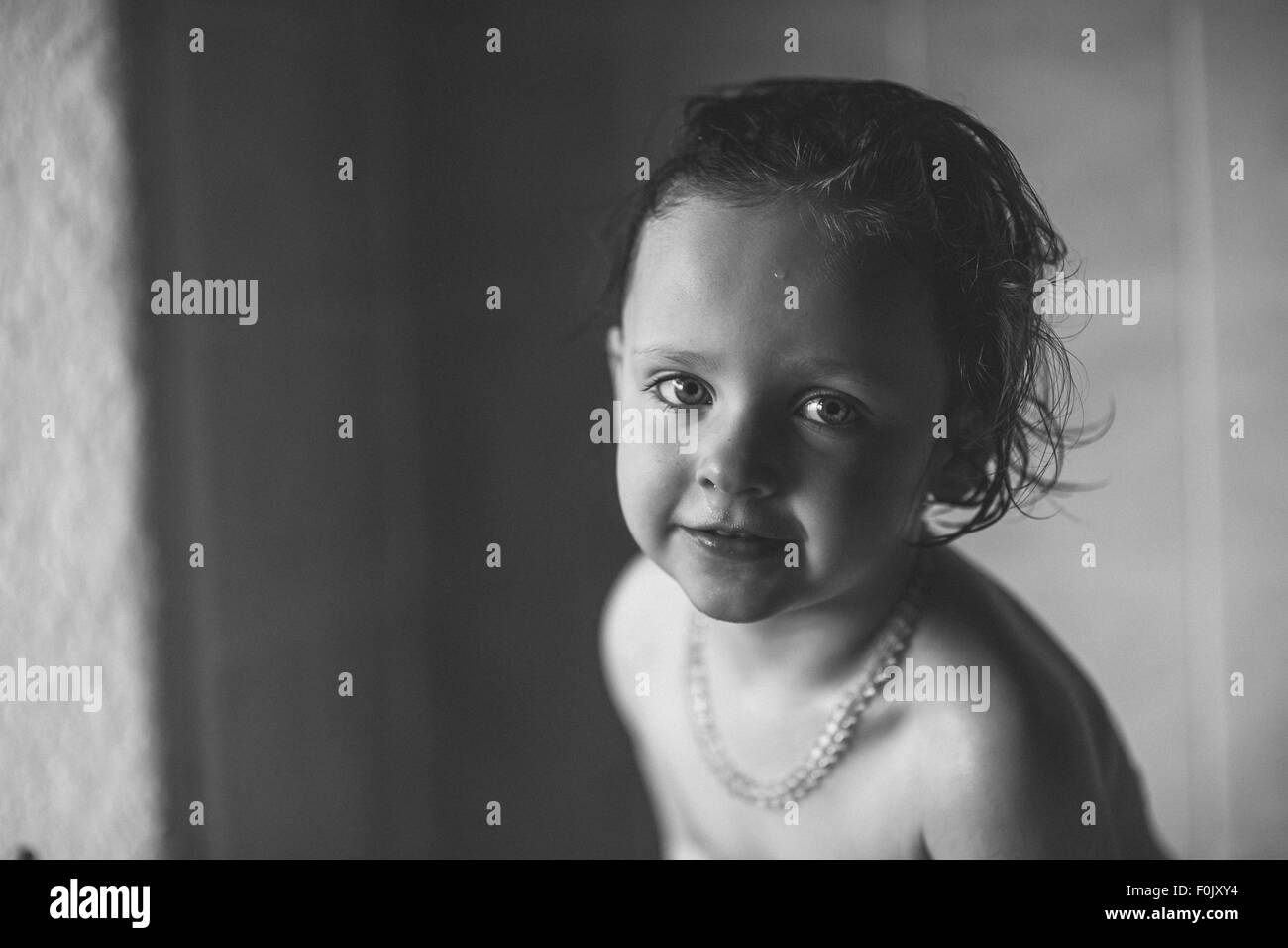 A young girl smiling at the camera Stock Photo - Alamy