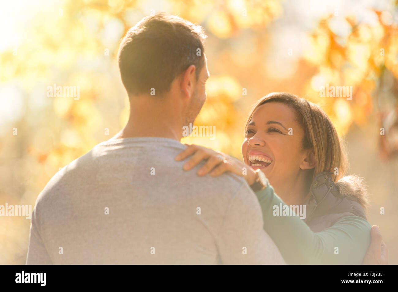 Laughing couple face to face outdoors Stock Photo