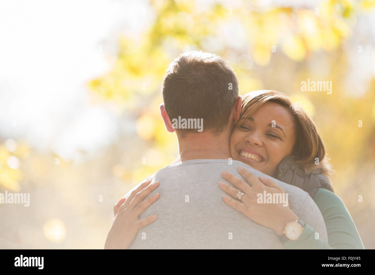 Enthusiastic couple hugging outdoors Stock Photo