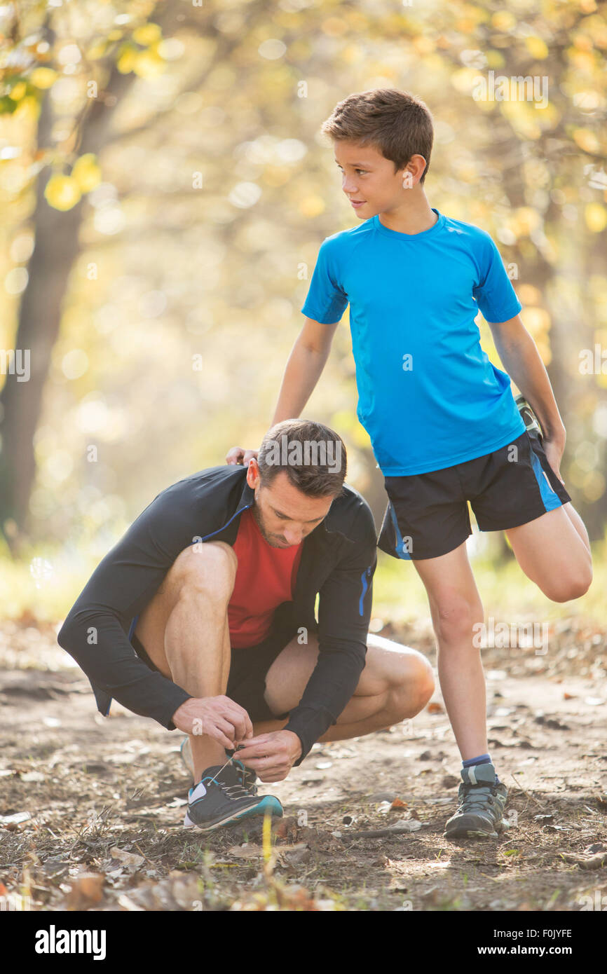 Father and son stretching and preparing to run Stock Photo