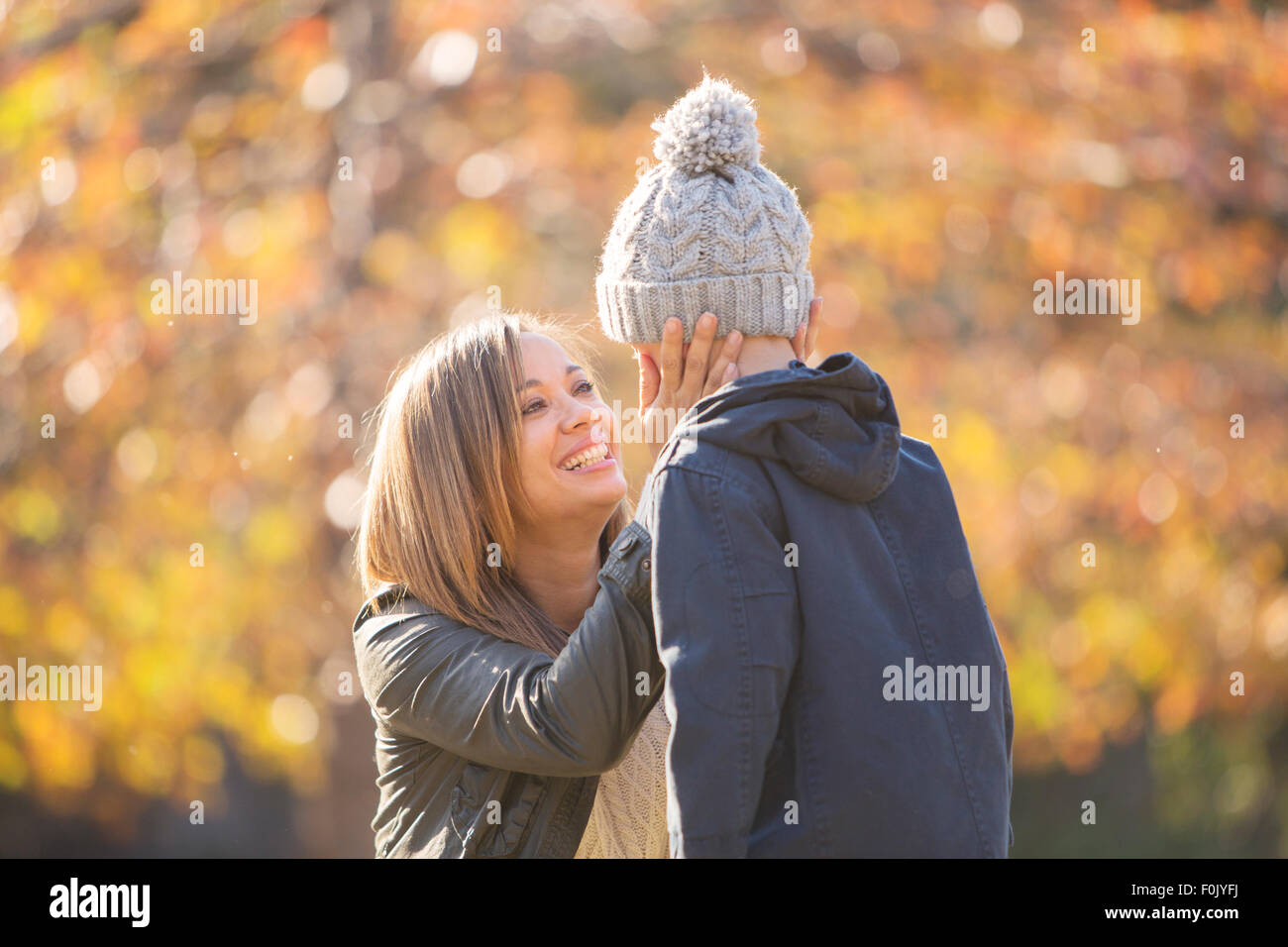 Affectionate mother touching son’s face outdoors Stock Photo
