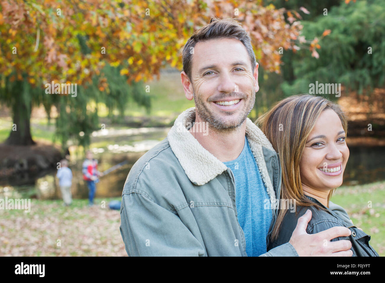 Portrait smiling couple at autumn park Stock Photo - Alamy