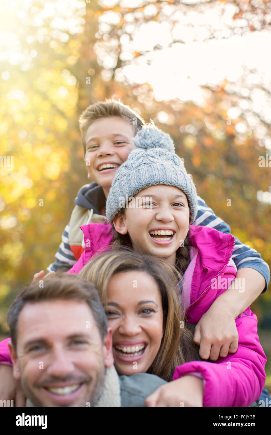 Portrait enthusiastic family hugging outdoors Stock Photo
