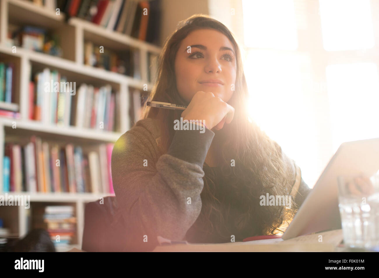 Pensive teenage girl with digital tablet Stock Photo