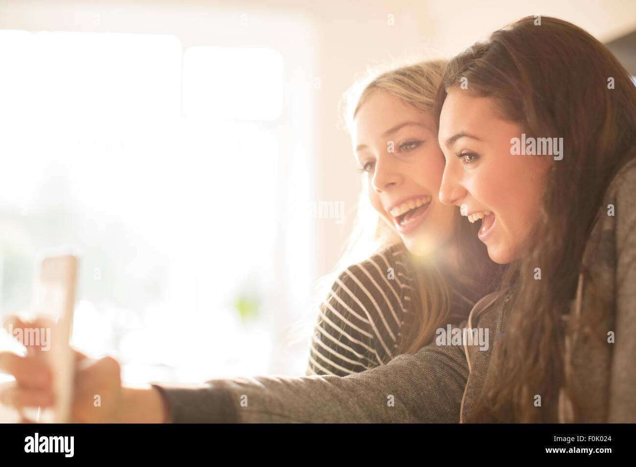 Teenage girls taking selfie with camera phone Stock Photo