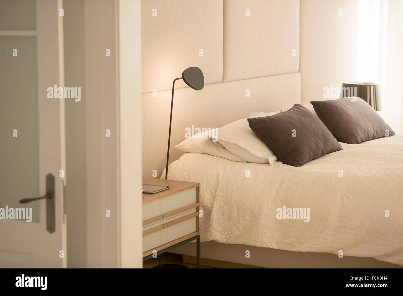 Illuminated lamp over bed Stock Photo Alamy