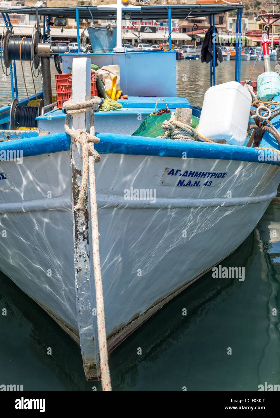 Small Greek fishing boat moored in harbour Stock Photo - Alamy