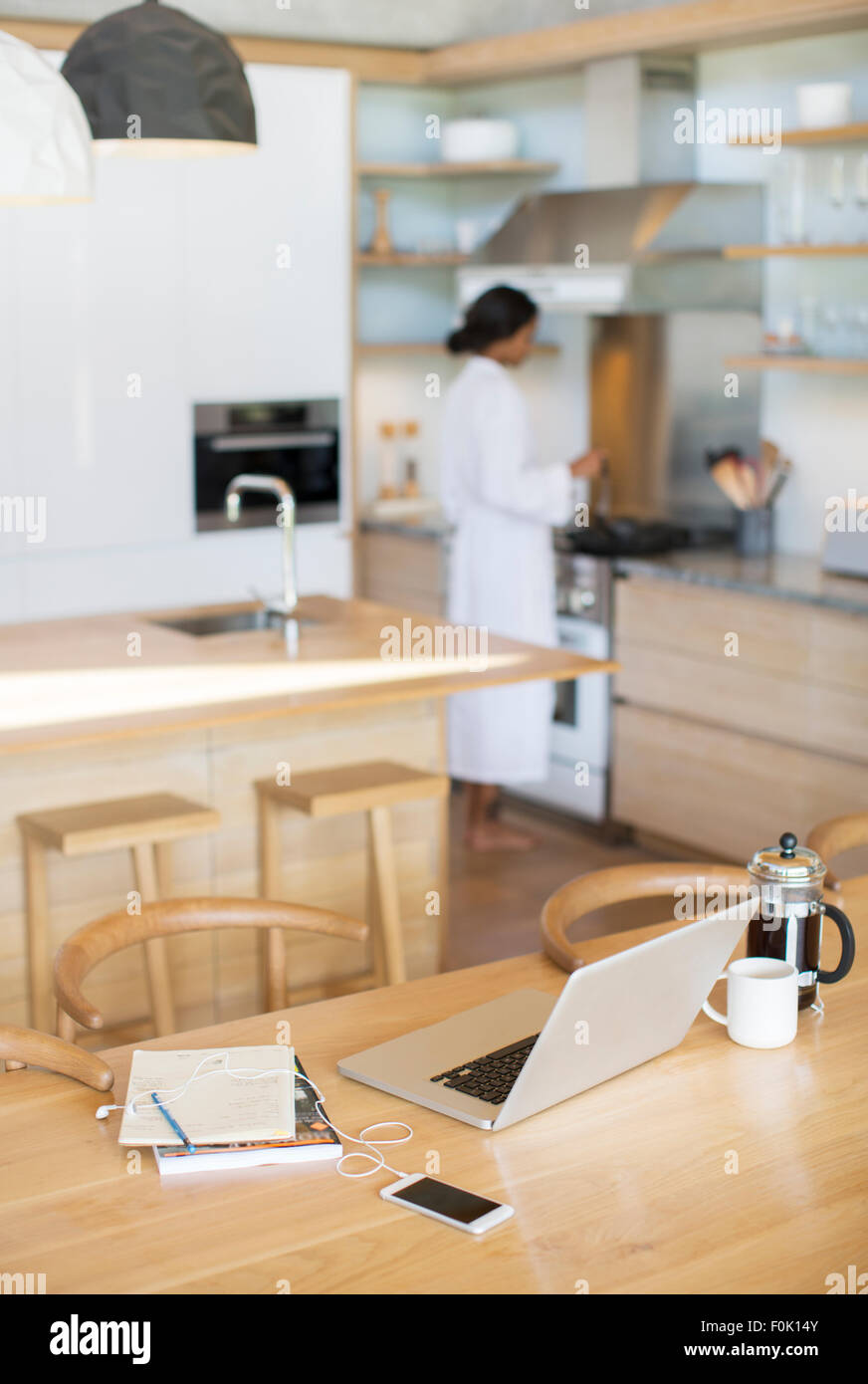 Laptop French Press Coffee Cell Phone And Notebook On Kitchen